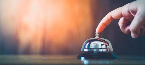 Finger pressing the button on a bell